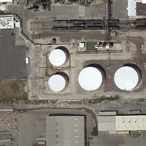 Aerial image containing four large storage tanks
